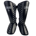 Kickboxing shin guards in black with built-in ankle protection
